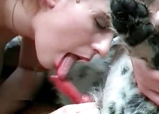 Blond-haired beauty blows a big-dicked dog
